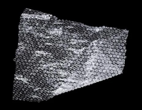 Transparent bubble wrap on black background, top view Stock Photos