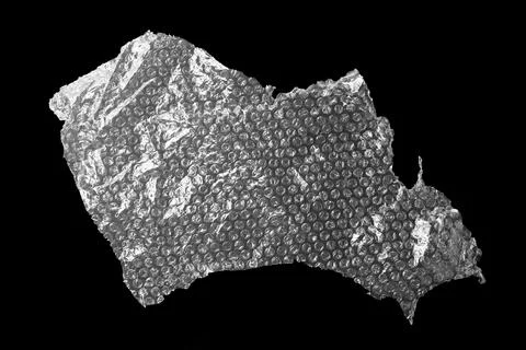 Transparent bubble wrap on black background, top view Stock Photos