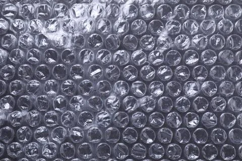Transparent bubble wrap on black background, top view Stock Photos