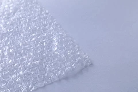 Transparent bubble wrap on gray background, closeup. Space for text Foto stock