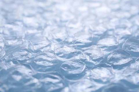 Transparent bubble wrap on light blue background, closeup Stock Photos