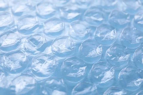 Transparent bubble wrap on light blue background, closeup Stock Photos