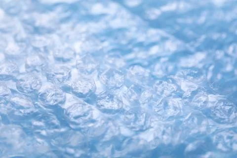 Transparent bubble wrap on light blue background, closeup Foto stock