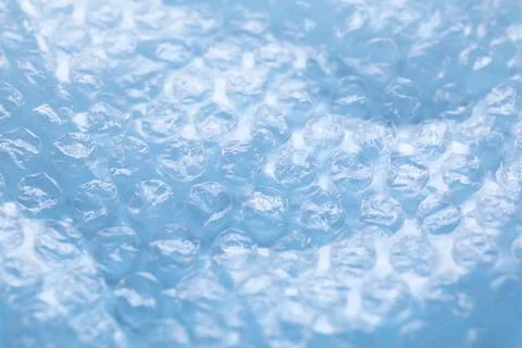Transparent bubble wrap on light blue background, closeup Foto stock