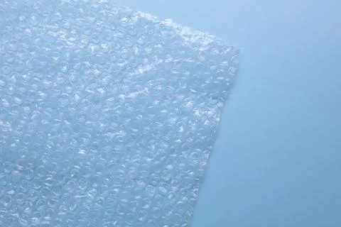 Transparent bubble wrap on light blue background, top view. Space for text Foto stock
