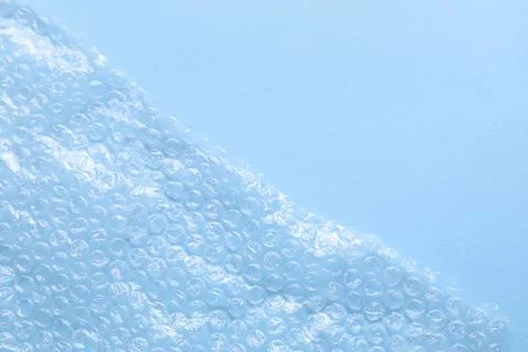 Transparent bubble wrap on light blue background, top view. Space for text Foto stock