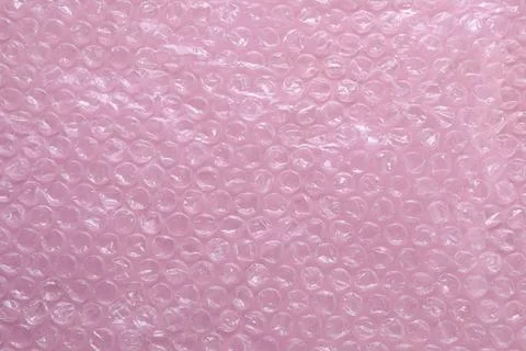 Transparent bubble wrap on pink background, top view Stock Photos