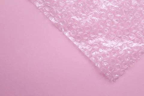 Transparent bubble wrap on pink background, top view. Space for text Stock Photos