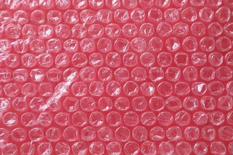 Transparent bubble wrap on red background, top view Stock Photos