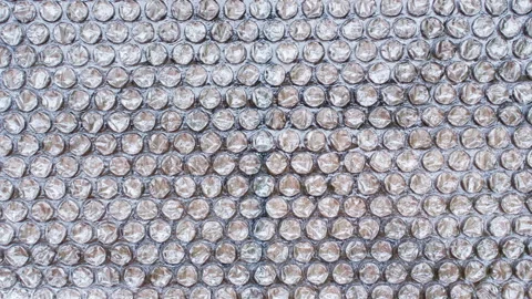 Transparent Bubble Wrap Shifts in a Seamless Stop Motion Loop, Forming a Clean A Stock Footage 340607462