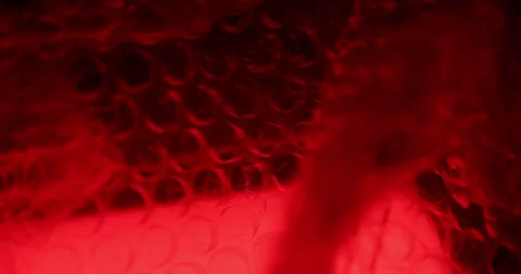 Transparent Bubble Wrap Texture Red light Stock Footage 313261886