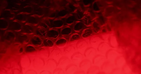 Transparent Bubble Wrap Texture Red light Stock Footage 313261888