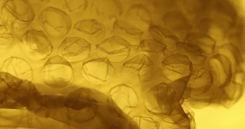 Transparent Bubble Wrap Texture Yellow light Stock Footage 313263867
