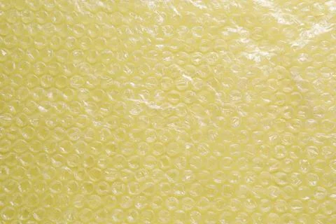 Transparent bubble wrap on yellow background, top view Foto stock
