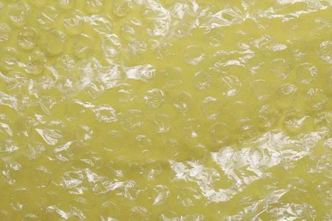 Transparent bubble wrap on yellow background, top view Foto stock