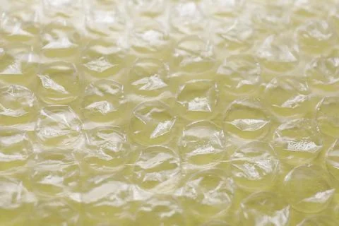 Transparent bubble wrap on yellow background, closeup Foto stock