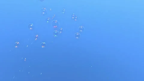 Transparent bubbles slowly rising in blue sky background Stock Footage 322659690