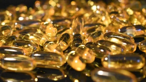 Transparent capsules on a black background Stock Footage 118922525