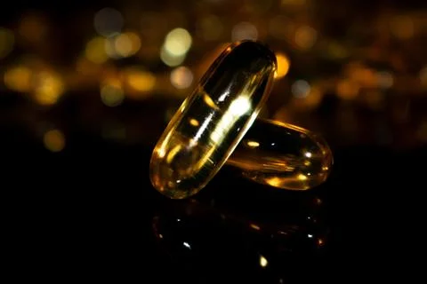 Transparent capsules on black background Stock Photos