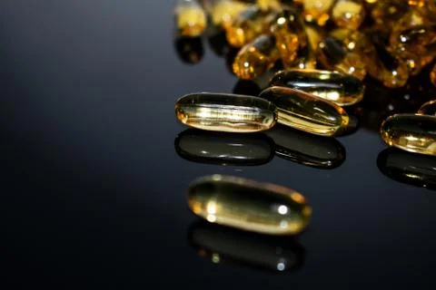Transparent capsules on black background Stock Photos