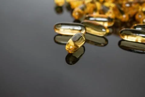 Transparent capsules on black background Stock Photos