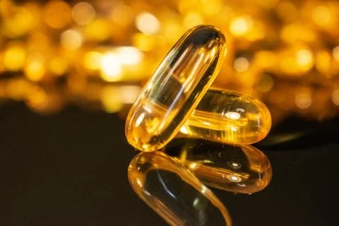 Transparent capsules on black background Stock Photos