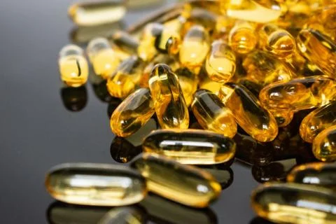 Transparent capsules on black background Stock Photos