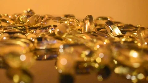 Transparent capsules on a gold background Stock Footage 118922622