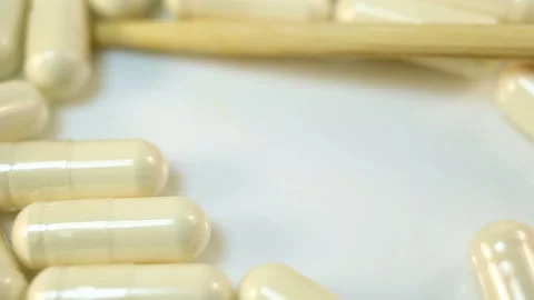 Transparent capsules with white powder extremely close-up, real time, medicine, Stock Footage 144642945