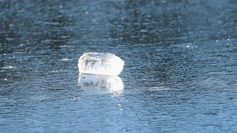 Transparent Chunk of Broken Ice on a Frozen River Surface Stock Footage 346139398