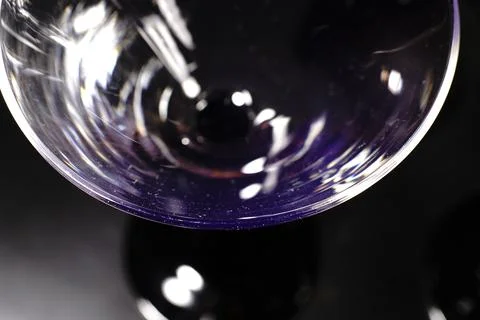 Transparent cocktail glasses on a black background in the bar. Closeup. Stock Photos