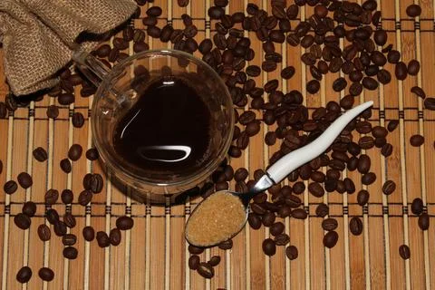 Transparent coffee mug on the background of beans and mats Stock Photos