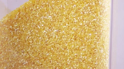 Transparent container with corn groats Stock Footage