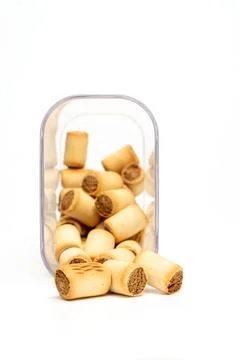 Transparent container with dog biscuits isolated on white background. Stock Photos