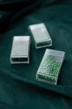 Transparent containers with green beads Stock Photos