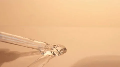 Transparent cosmetic drop with bubbles on a beige background. Stock Footage 218314013