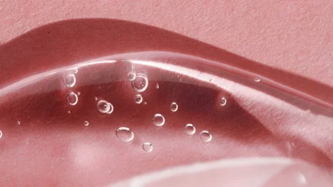 Transparent cosmetic texture with bubbles, smear on a pink background Vídeos de archivo 233591698