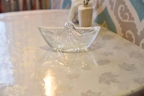 Transparent crystal dish on patterned light beige marble table surface with.. Stock Photos