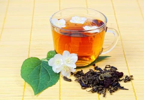 Transparent cup with tea with a jasmine Фото