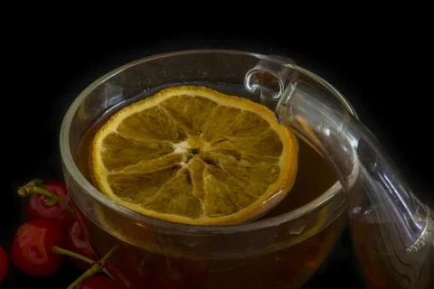 Transparent cup of tea with orange Stock Photos