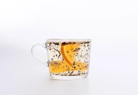 Transparent cup of tea with slice of orange isolated on white background Stock Photos