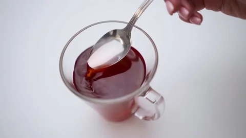 Transparent cup of tea. The spoon is immersed in red tea. Stock Footage 189203309