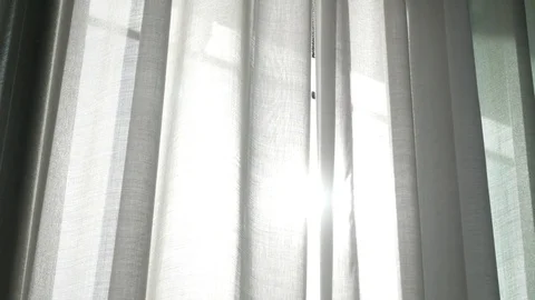 A transparent curtain on the window, gently moved by the wind. sunlight. 4k Stock Footage 83171784