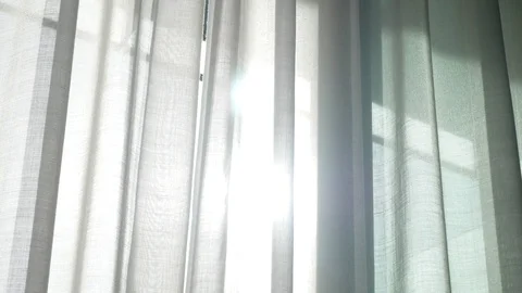 A transparent curtain on the window, gently moved by the wind. sunlight. 4k Stock Footage 83261485