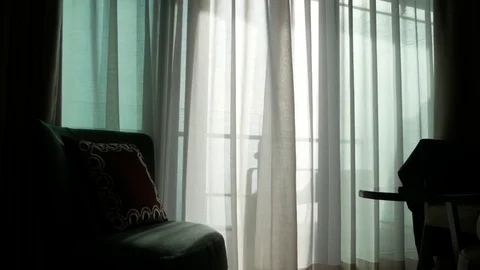 A transparent curtain on the window, gently moved by the wind. sunlight. 4k Stock Footage 83261907