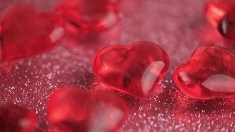 Transparent decorative red hearts fall shiny pink background. close up. Stock Footage 263180168