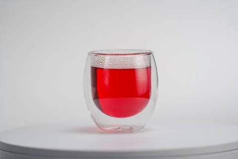 Transparent double wall glass, with red tea, on white background. Stock Photos