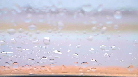 Transparent drops on window after heavy rain, dropping rain on the glass, wet Stock Footage 258296145