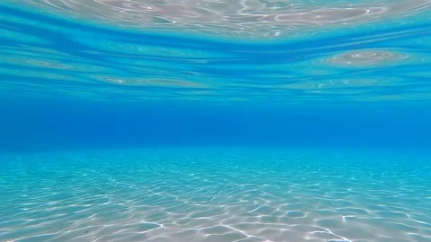 Transparent empty blue underwater view and white sand at the bottom in shallow Stock Footage 252677333
