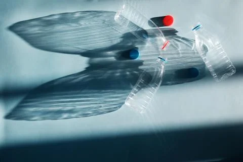 Transparent empty three plastic bottle for ecological recycled backlit by bri Stock Photos